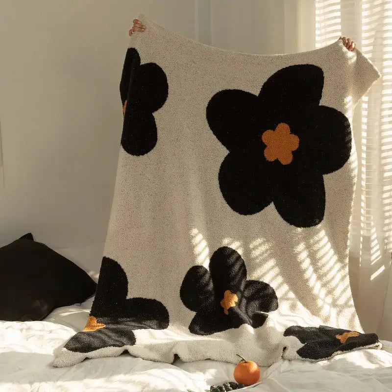 Cream korean kawaii flower plush throw blanket in cream with bold black floral patterns and orange centers decorbites korean kawaii