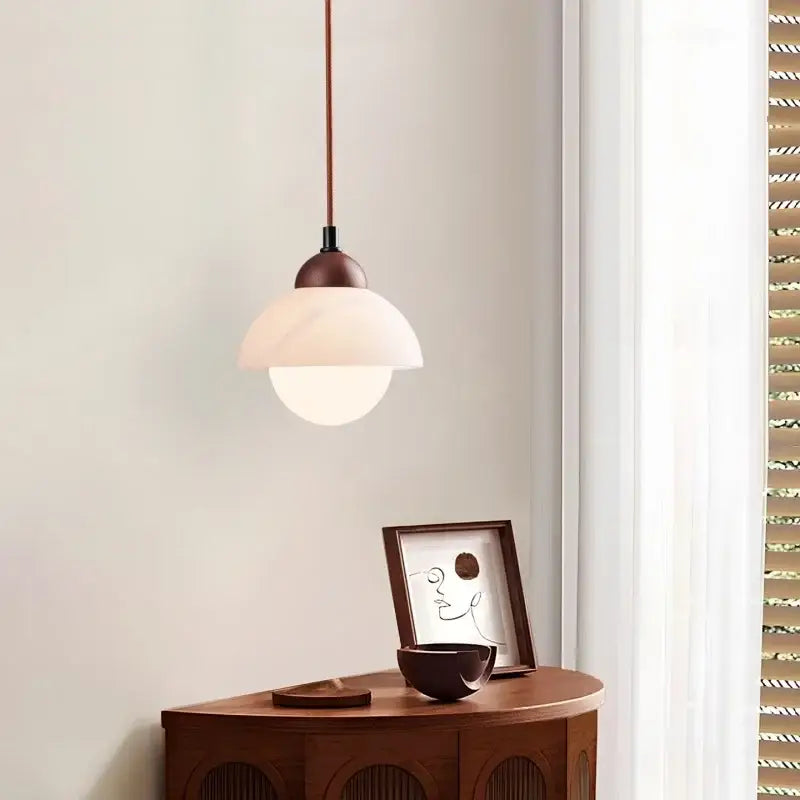 Minimalist pendant light with warm brown metal fixture and dual-layered frosted glass shade for bedroom decorbites cream marble led