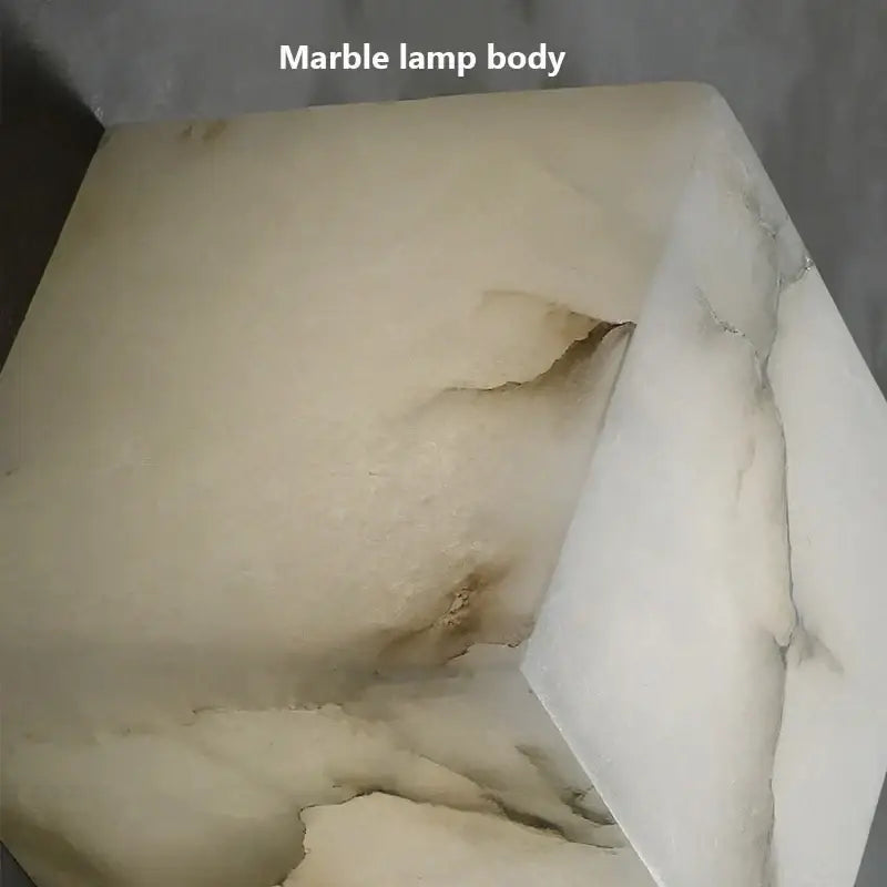 Cream onyx cube marble wall lamp with smooth off-white body and natural stone edges for bedroom decorbites cube marble sconce