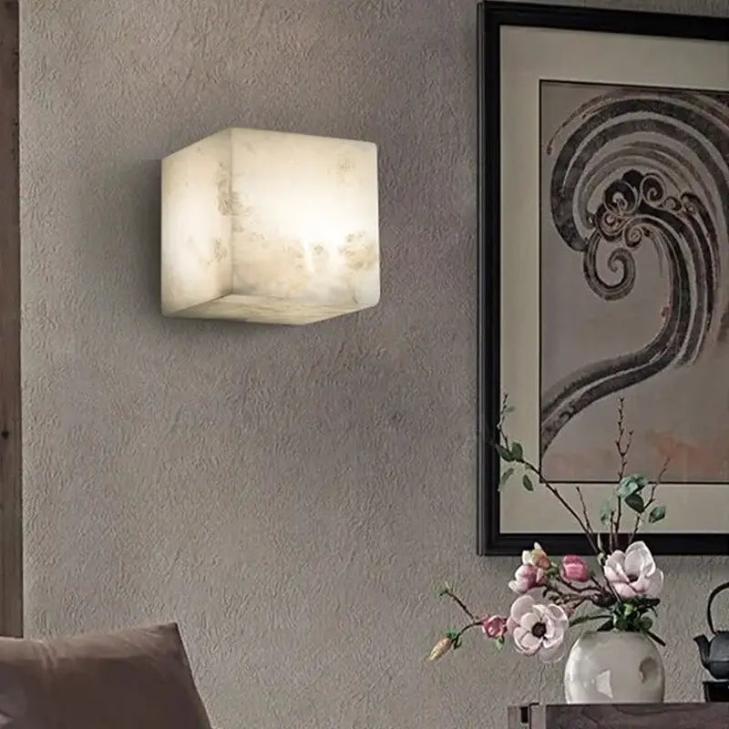 Cream onyx cube marble wall lamp with softly glowing off-white natural stone finish for bedroom decorbites cube marble decor