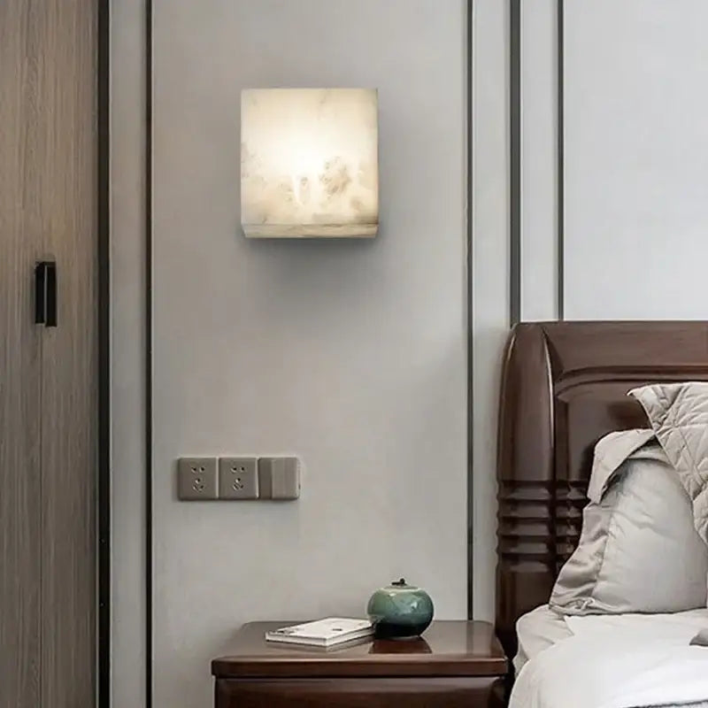 Cream onyx cube marble wall lamp with softly glowing translucent white marble finish for bedroom decorbites cube marble wall
