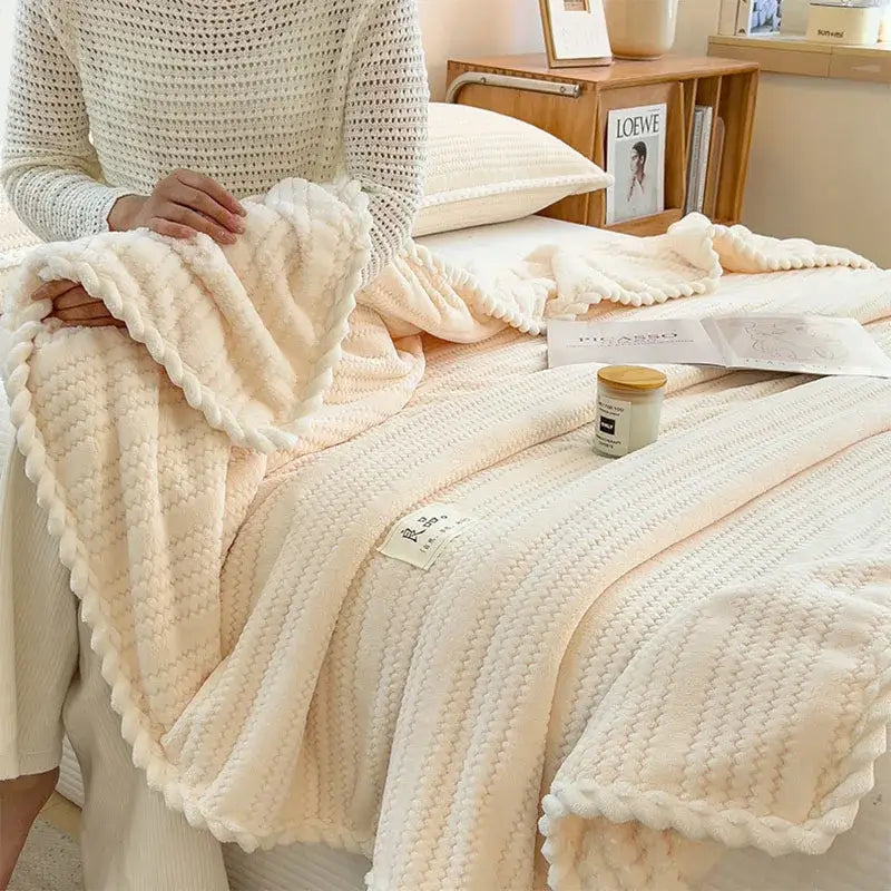 Cream plush double sided jacquard milk velvet blanket with textured knit pattern and braided edge for bedroom throw