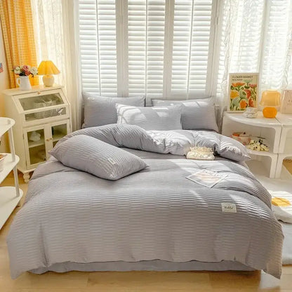 Light gray ribbed cotton duvet cover set with matching pillows and small white label for bedroom bedding use