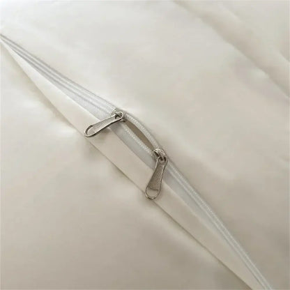Cream satin 1000tc egyptian cotton bedding set with white satin zipper and silver-toned metal sliders on smooth fabric