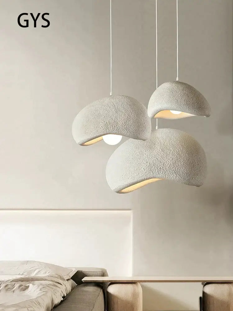 Three off-white textured cream style cloud pendant lamps hanging as dining room decorbites cream style lighting