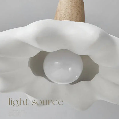 A sleek white ceramic clamshell cream style led pendant light with wooden stem for bedroom decorbites cream style use