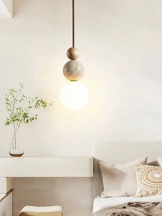 A cream style led pendant lamp with stacked concrete and wood spheres emitting warm light for bedroom decorbites decor