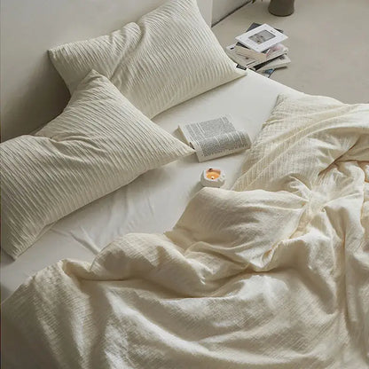 Cream textured cotton foam yarn bedding set featuring cream pillowcases with a subtle ribbed pattern for bedroom use