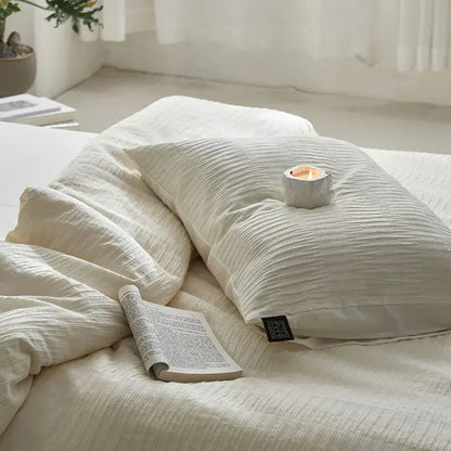 Cream textured cotton foam yarn bedding set featuring a ribbed duvet and a cream-colored textured pillow with black tag