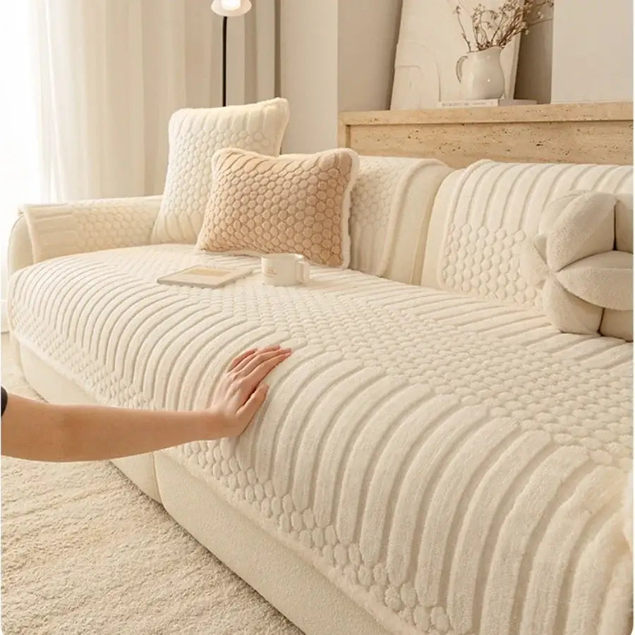 Cream textured jacquard knit plush sofa cover with a quilted honeycomb pattern for living room use