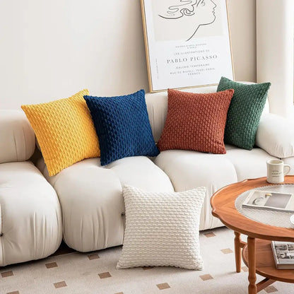 Four colorful textured throw pillows in yellow blue rust and green enhance living room decor with decorative pillow covers