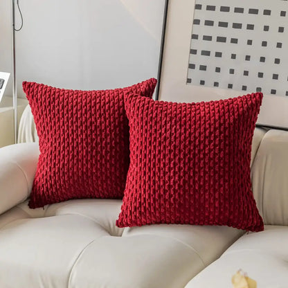 Two vibrant red chunky-knit decorative pillow covers with ribbed texture on white sofa for decorbites pillow cover decor