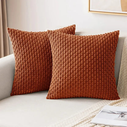 Two rust-colored corduroy throw pillows with ribbed texture complement cream knit decorative pillow cover decorbites decor