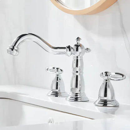 Cream white bathroom set featuring chrome-finished vintage style faucet with ornate detailing and two handles and towel rack