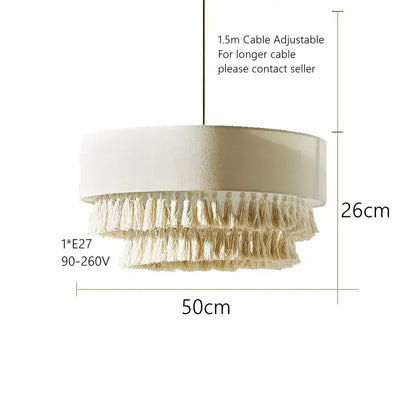 Cream-colored tiered pendant light with textured cylindrical top and cascading tassels perfect for decorbites creamy bohemian interiors