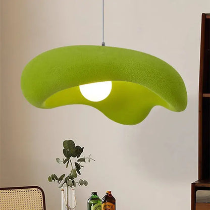 A vibrant lime green plush-textured creamy style pendant light with an organic leaf-like shape for dining room decor
