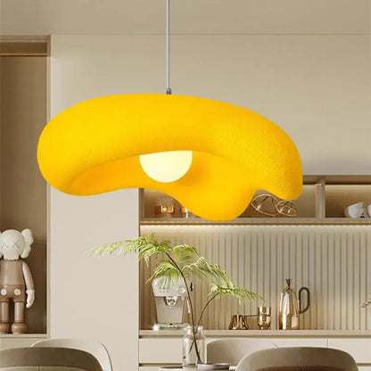 A vibrant yellow creamy style resin pendant light with a textured surface and soft glow for dining room use