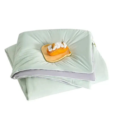 A soft creamy white and mint green ice cream silk quilt with subtle sheen and gray trim by decorbites ice cream
