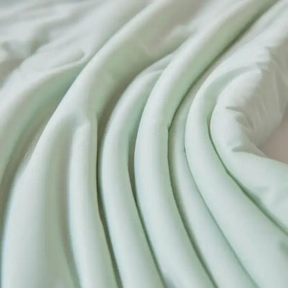Soft pale mint green fabric with gentle folds in decorbites ice cream silk cream silk quilt for bedroom use