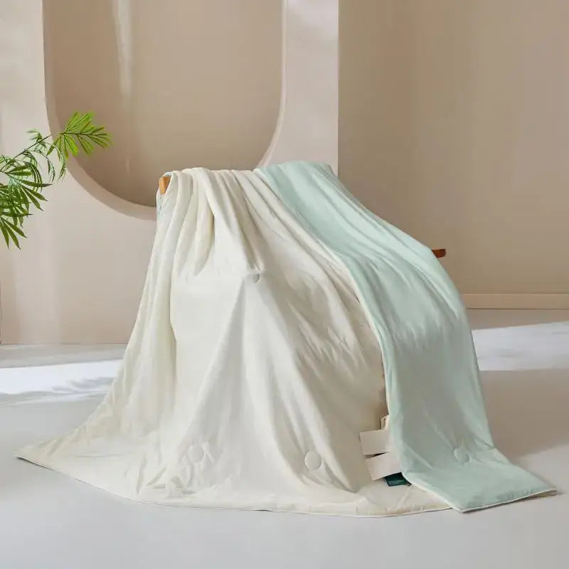 A creamy white and pale mint green cream silk quilt with a smooth plush finish for bedroom decorbites ice cream silk blanket