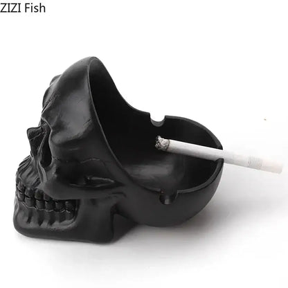 Creative black skull ashtray with matte finish and detailed facial features holding a cigarette for living room use