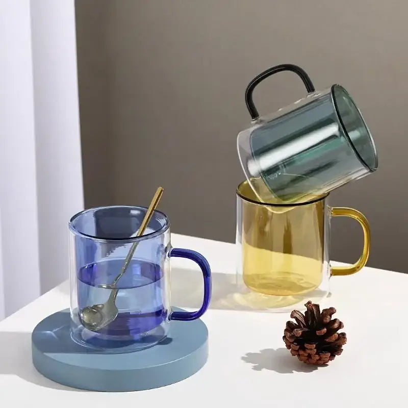 Creative blue and green whiskey wine glass tumbler set featuring a blue-tinted double-walled glass mug with gold spoon