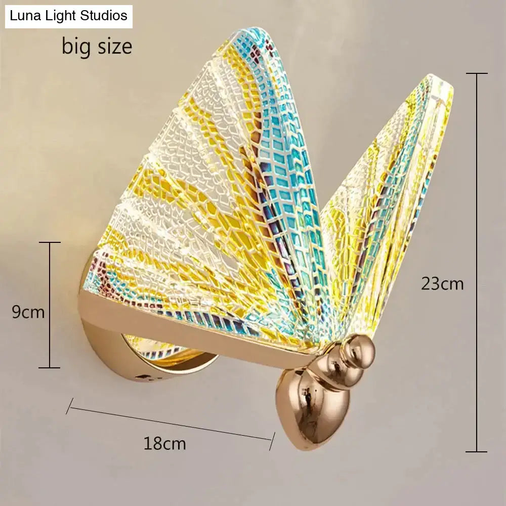Creative colorful butterfly led wall lamp with intricate yellow blue and white mosaic wings and gold metallic body for bedroom use