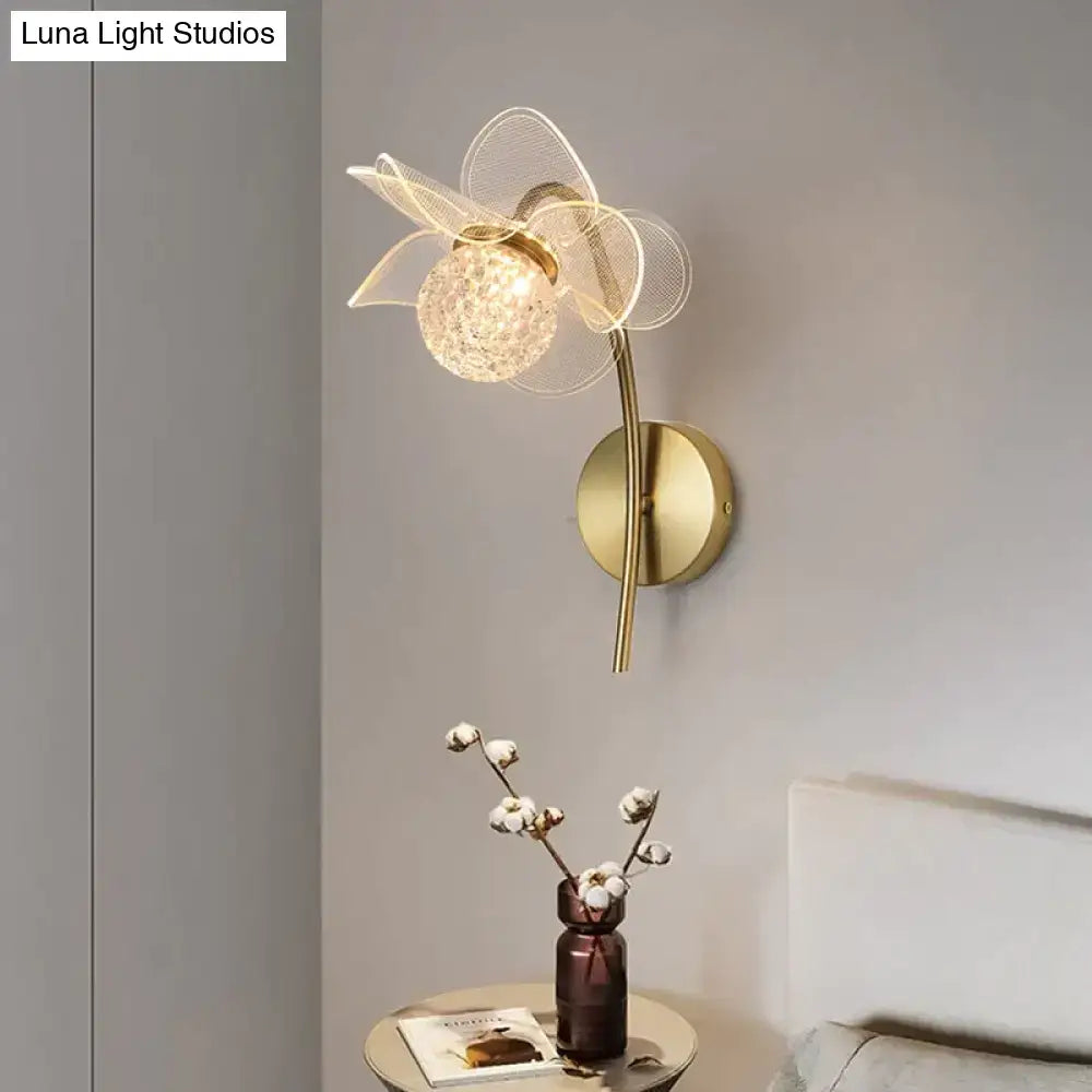 Creative floral decorative gold led wall lamp with delicate wireframe flower design and faceted crystal center for bedroom