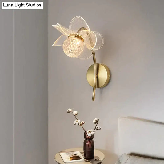 Creative floral decorative gold led wall lamp with delicate wireframe flower design and faceted crystal center for bedroom