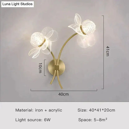 Gold-toned creative floral decorative led wall sconce with two translucent flower-shaped iron and acrylic fixtures for bedroom