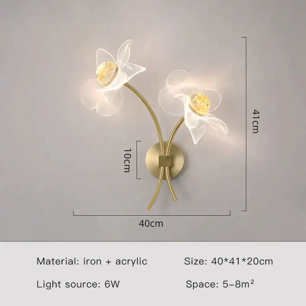 Creative floral decorative gold led wall sconce with two translucent acrylic flowers and warm amber centers for bedroom