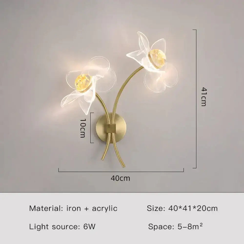 Creative floral decorative gold led wall lamp with two white acrylic flower fixtures and amber crystal accents for bedroom