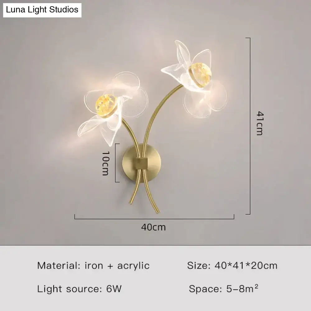 Creative floral decorative gold led wall lamp with brass-toned sconce and translucent white acrylic flowers in bedroom use