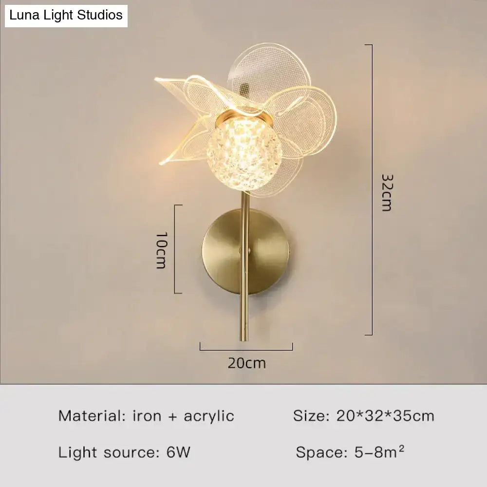 Creative floral decorative gold led wall lamp featuring a faceted crystal globe and sheer mesh petals for bedroom use