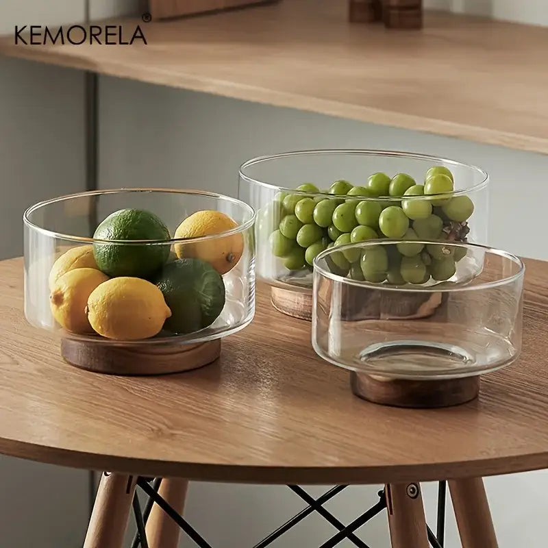 Clear glass fruit bowl with wooden base by decorbites holding lemons limes and green grapes for creative glass fruit display