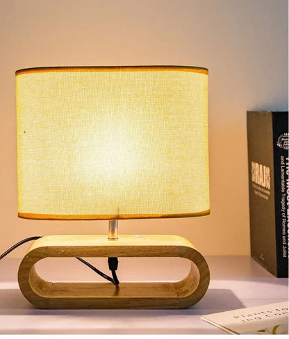Warm-toned beige linen creative nordic wooden table lamp with textured fabric shade and oval cutout wooden base for bedroom decorbites creative nordic