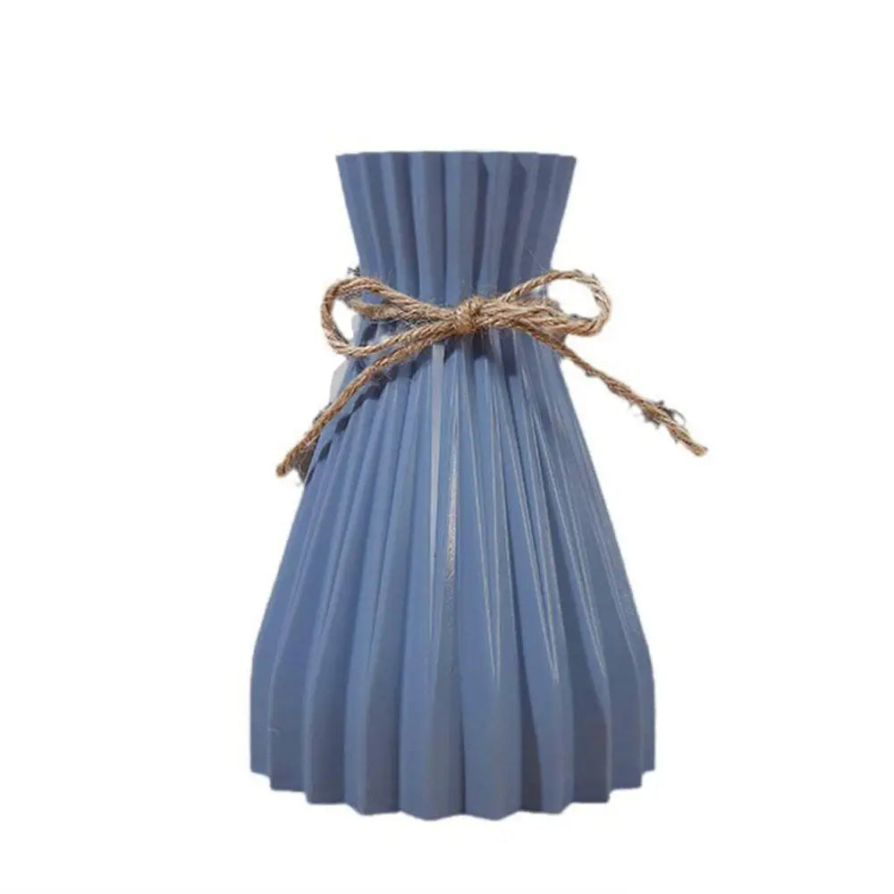 A blue pleated ceramic flower bottle type with a rustic twine bow designed as a dry flower bottle