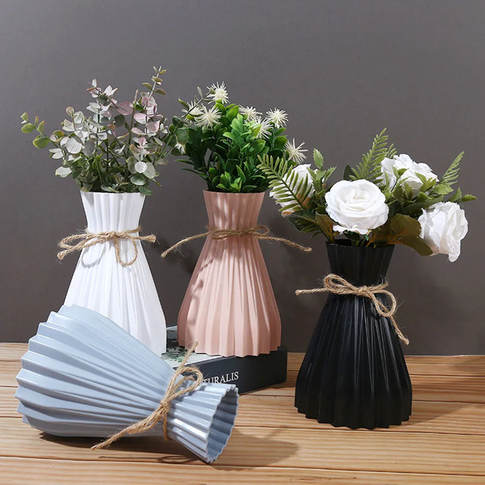 Set of three modern ceramic flower bottles in white blush pink and black with pleated design and rustic twine ties