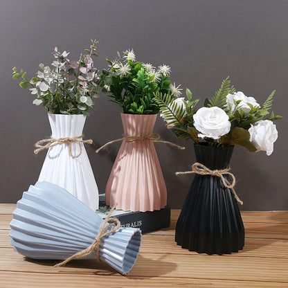 Set of three modern ceramic flower bottles in white blush pink and black with pleated design and rustic twine ties