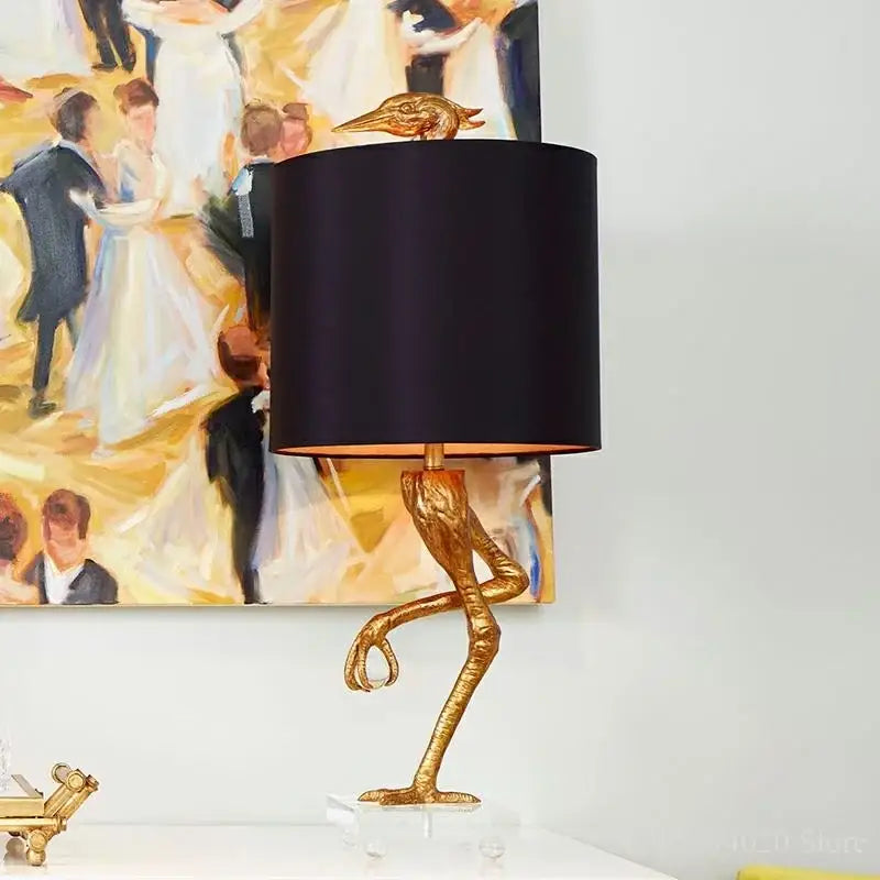 Golden bird-shaped table lamp with black satin shade and clear acrylic base from decorbites creative ostrich table collection