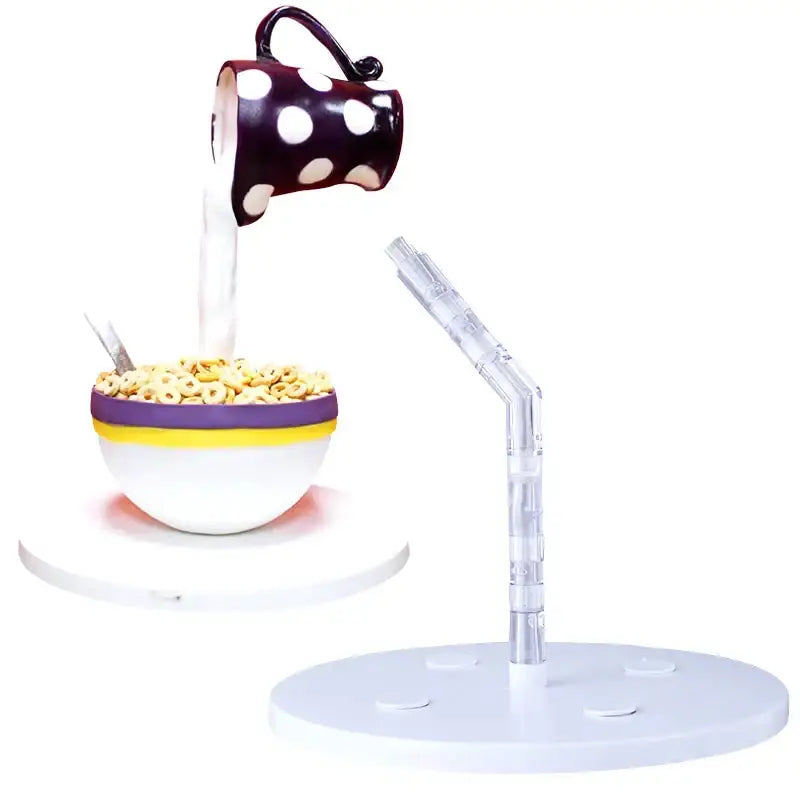 A whimsical ceramic cereal bowl with a purple and yellow rim on a creative red and white cake stand support for kitchen use