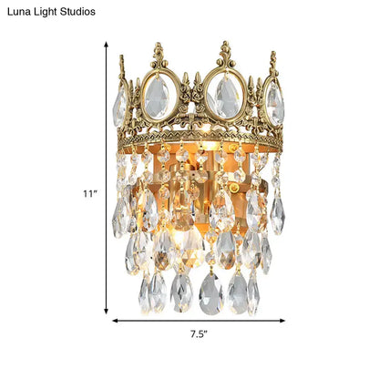 Gold-toned crown aged brass round wall mounted lighting with clear crystal prisms for bedroom decor