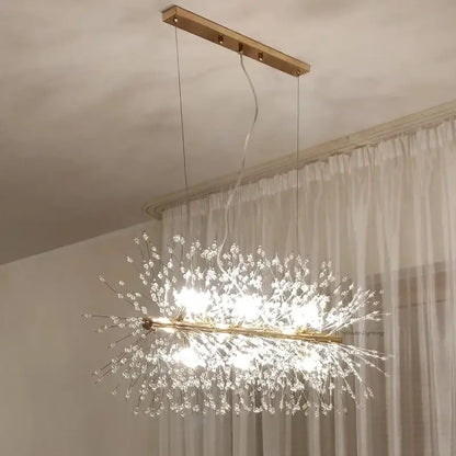 A modern gold-toned decorbites dandelion chandelier pendant lamp with clear crystal strands for dining room use