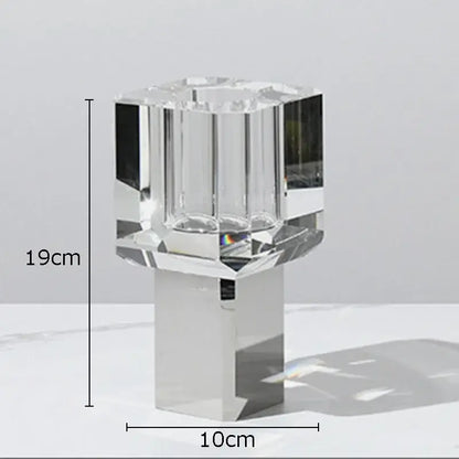 Crystal clear glass candle holder with faceted design and sleek silver base for elegant living room decor