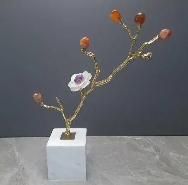 Golden branch tree sculpture with amber gemstone buds and white flower centerpiece on white marble base decorbites crystal flower