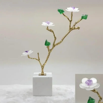 Delicate gold-toned crystal flower tree sculpture with white blossoms and green gemstone leaves on white marble base decorbites decor