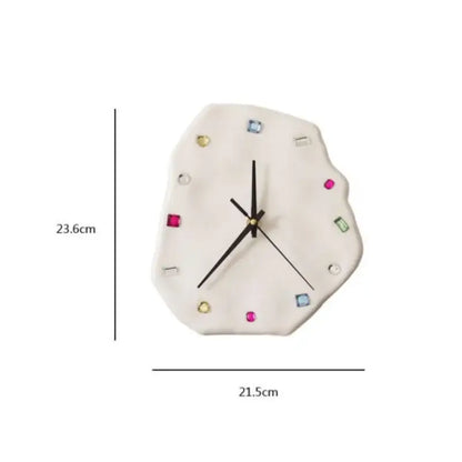 A white irregularly shaped wall clock with colorful gemstone markers and gold hands for decorbites crystal geometric wall decor