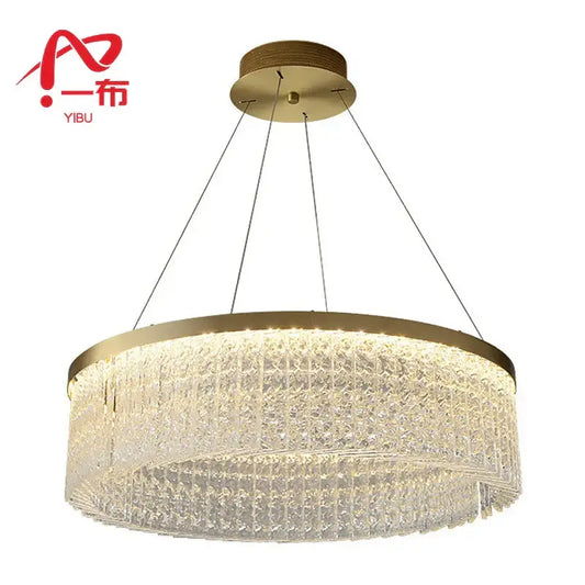 Gold-toned crystal glass gold pendant chandelier with cascading tiers emitting warm glow for dining room decorbites