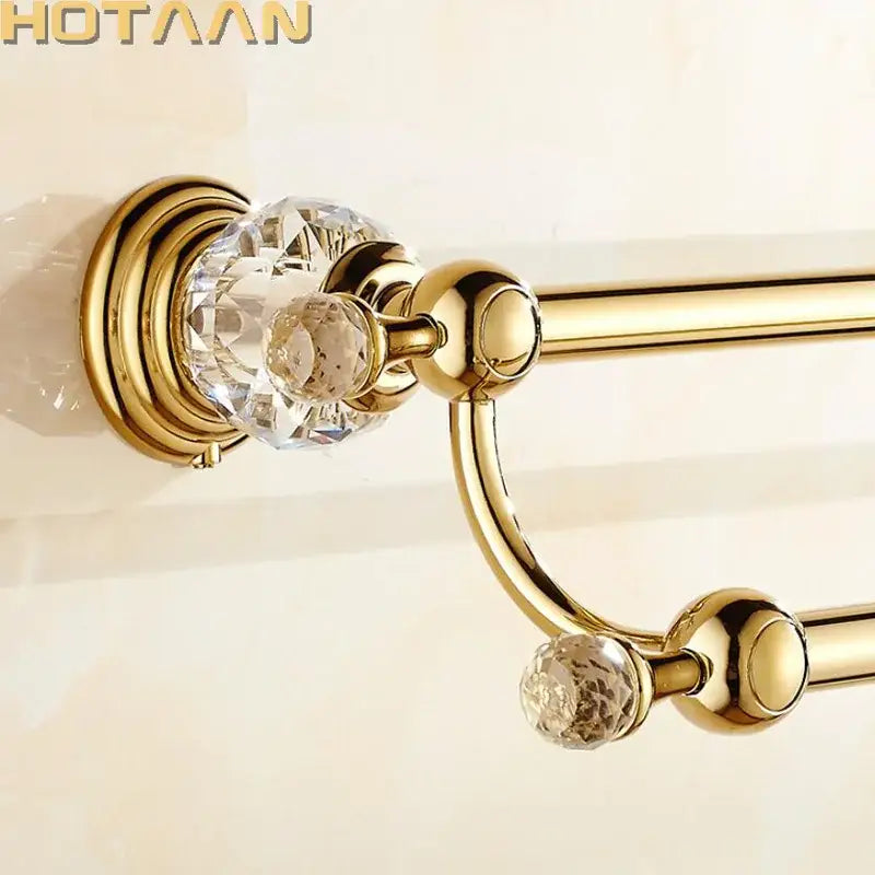 Gold finished double towel bar with crystal embellishments designed as a stylish double towel rack for bathroom use