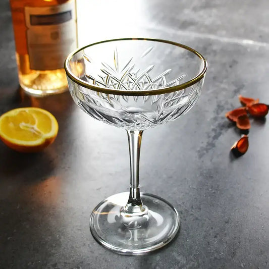 A clear crystal gold rim coupe glass with intricate cut-glass pattern for decorbites gold rim collection